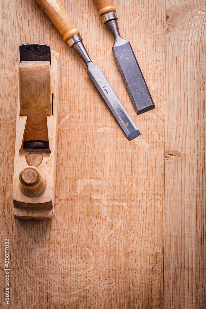 chisels and woodworkers plane on wooden board construction conce