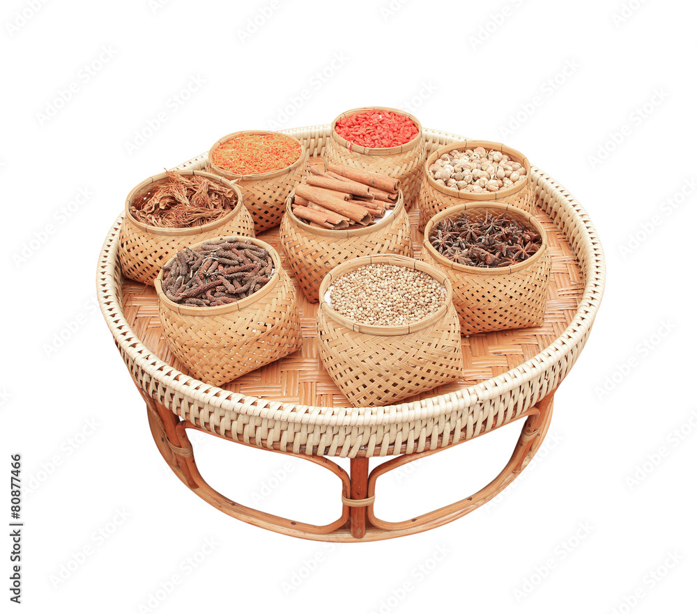 Spices, herbs in bamboo basket isolated on white background Spices, herbs in bamboo basket isolated on white background