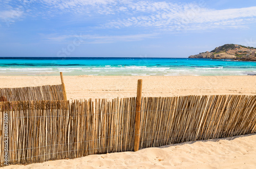 Wind fence on Cala Agulla beach  Majorca island  Spain