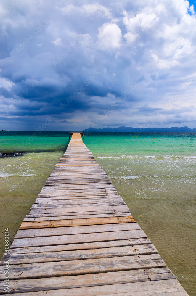 Wooden pier on Alcudia beach, Majorca island, Spain Wooden pier on Alcudia beach, Majorca island, Spain