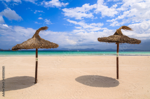 Umbrellas on sandy Alcudia beach, Majorca island, Spain