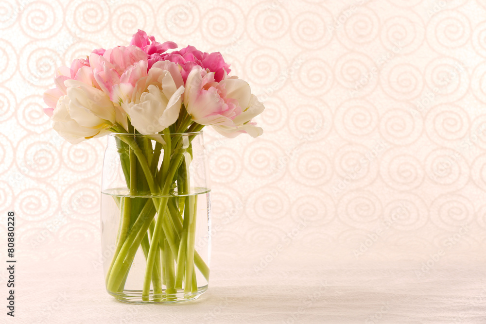 Fototapeta premium Bouquet of fresh tulips on pattern wallpaper background