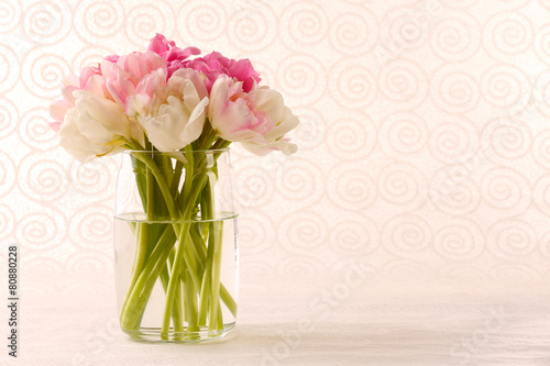 Bouquet of fresh tulips on pattern wallpaper background