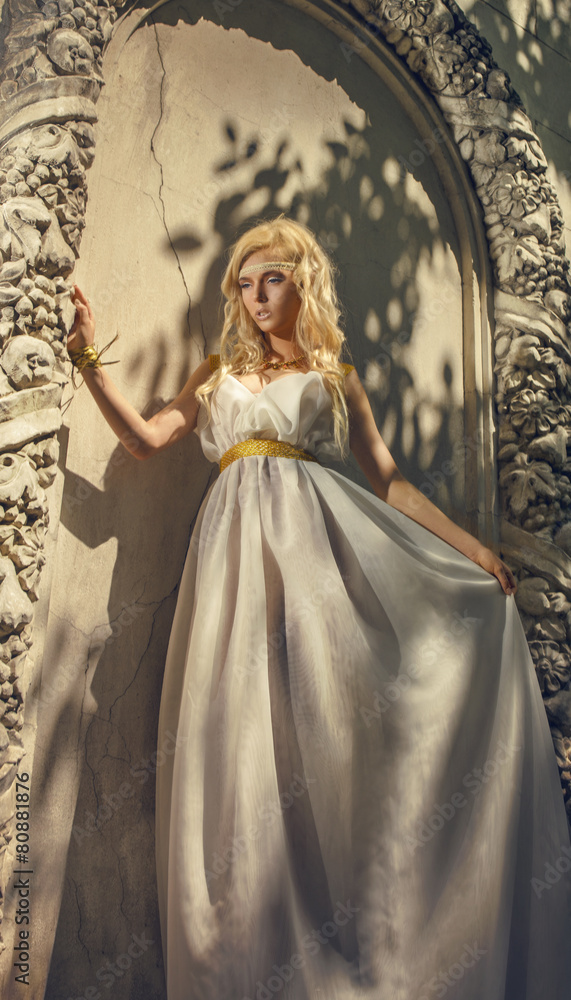 Pretty woman in white dress in the Greek style