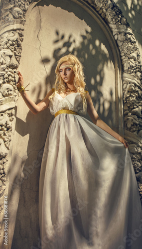 Pretty woman in white dress in the Greek style