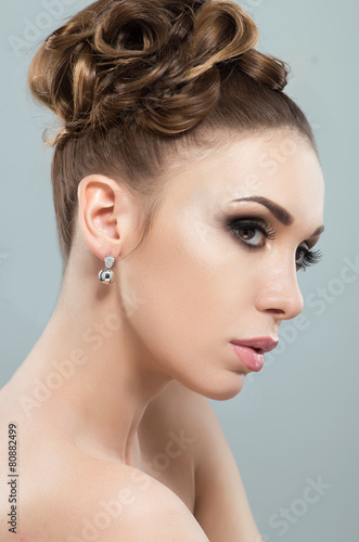 Beautiful woman with evening makeup and hairstyle