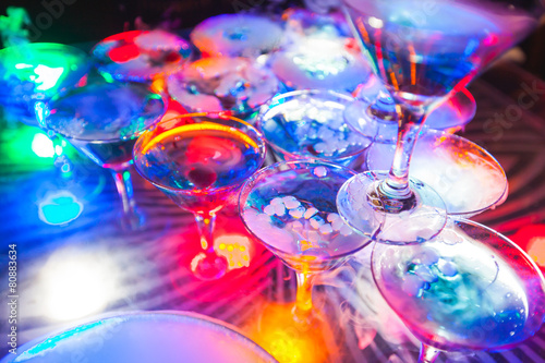 Line of different colored cocktails with smoke on a party