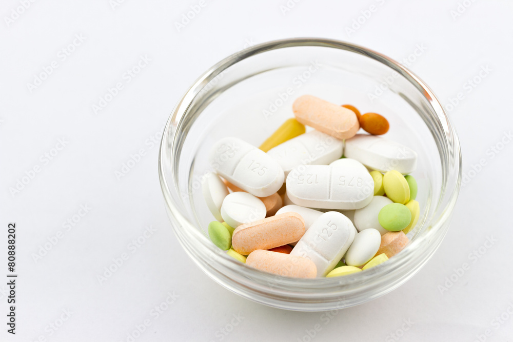 Top view of different pills, tablets and capsules in the plate Top view of different pills, tablets and capsules in the plate