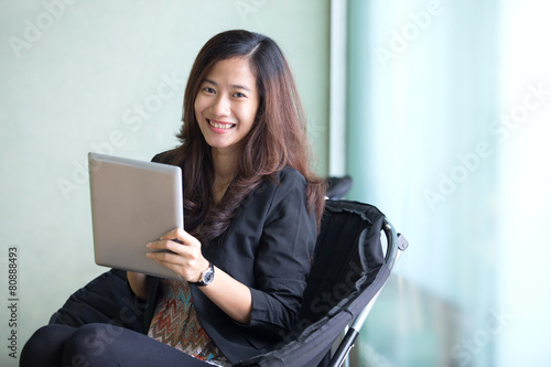 Happy young Businesswoman with a tablet pc