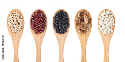 Different sorts of beans on wooden spoon