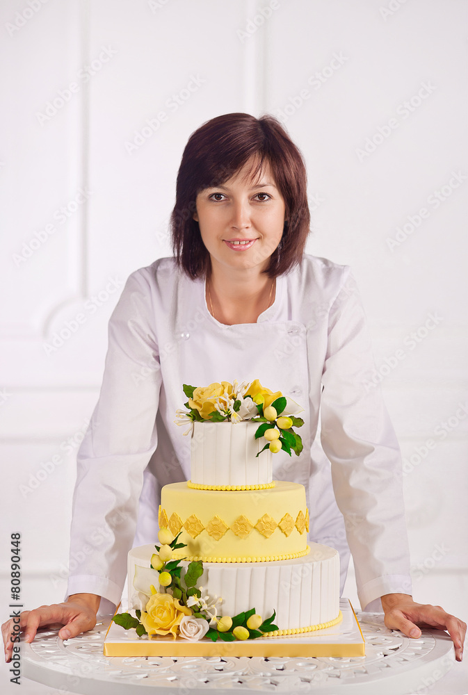 confectioner, baker or pastry cook preparing cake confectioner, baker or pastry cook preparing cake