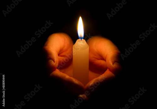 Religious concept. Man hands holding a burning candle