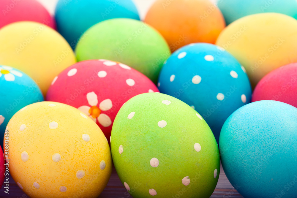 Easter eggs on white wooden desk. Festive background toning 