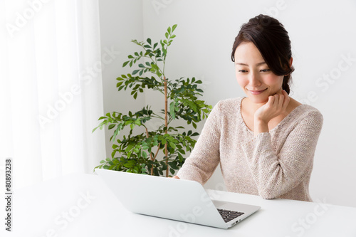 young asian woman using laptop © taka