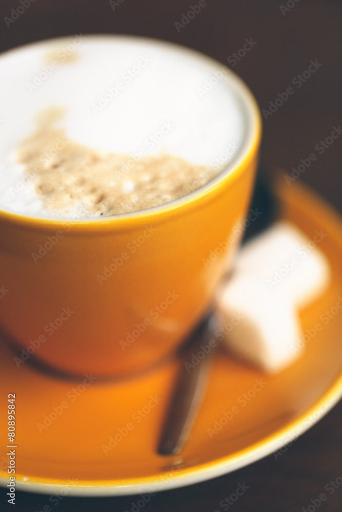 Yellow cup of Cappuccino