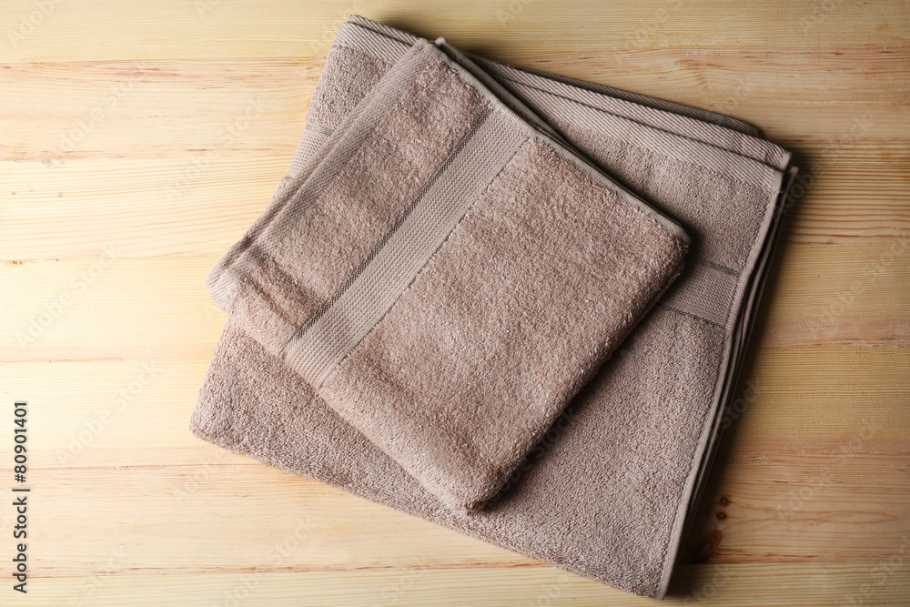 Brown towels on wooden background Brown towels on wooden background