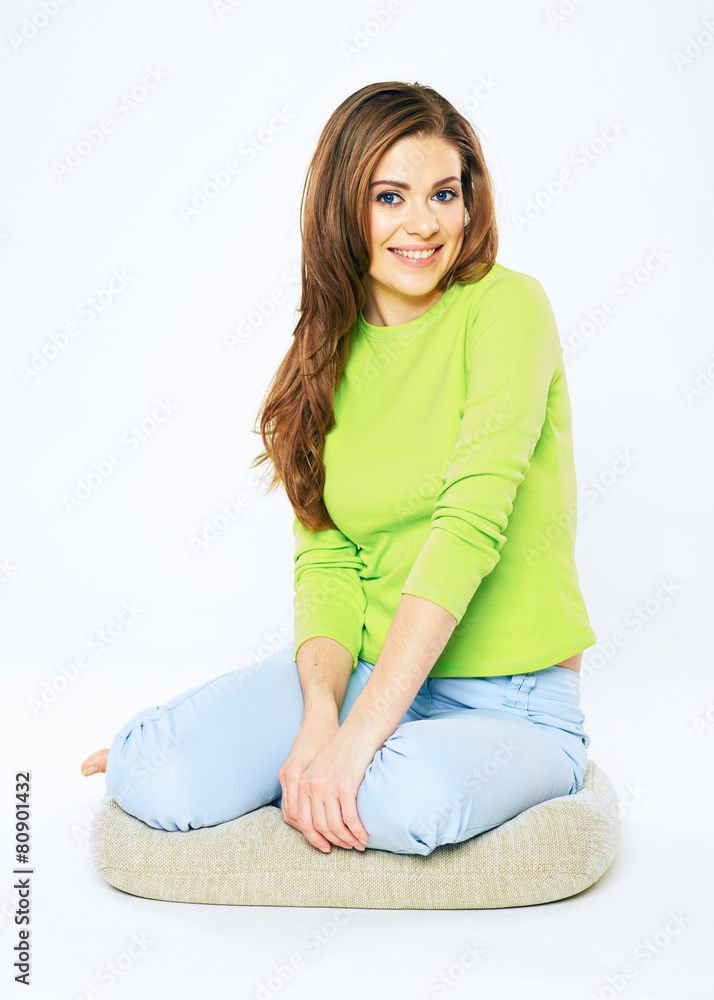 Young woman sitting on floor. Isolated white backgroun Young woman sitting on floor. Isolated white backgroun