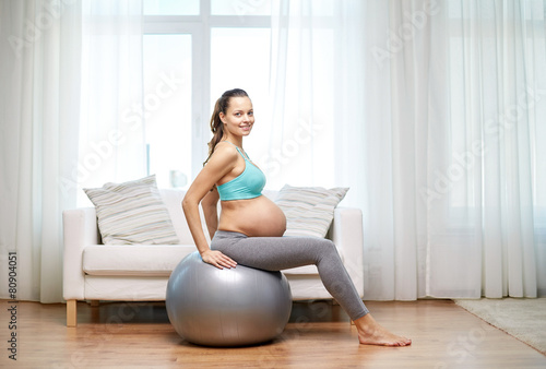 happy pregnant woman exercising on fitball at home © Syda Productions