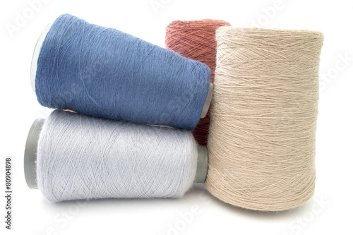 colorful threads and yarns on a white background isolated