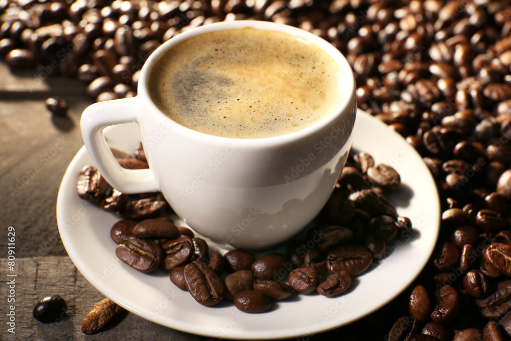 Cup of coffee with grains, closeup Cup of coffee with grains, closeup