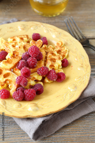 Waffles and raspberries on a plate