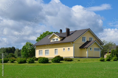 Wooden house in the countryside. Sunny summer day