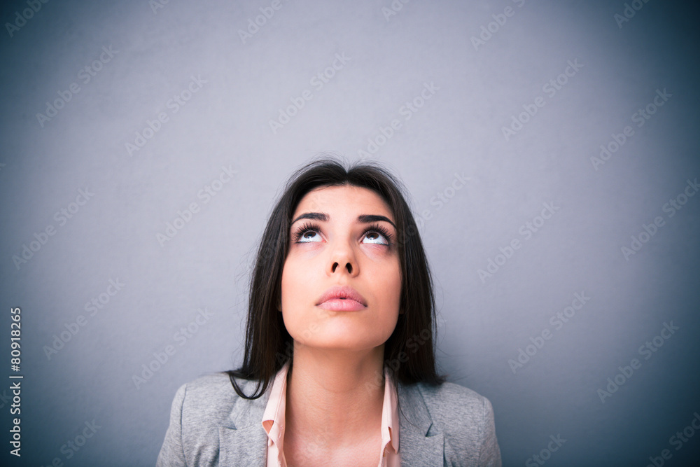 Fototapeta premium Closeup portrait of attractive young woman looking up