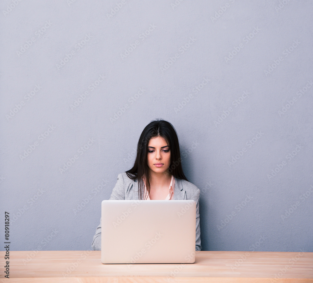 Charming woman sitting at the table with laptop Charming woman sitting at the table with laptop