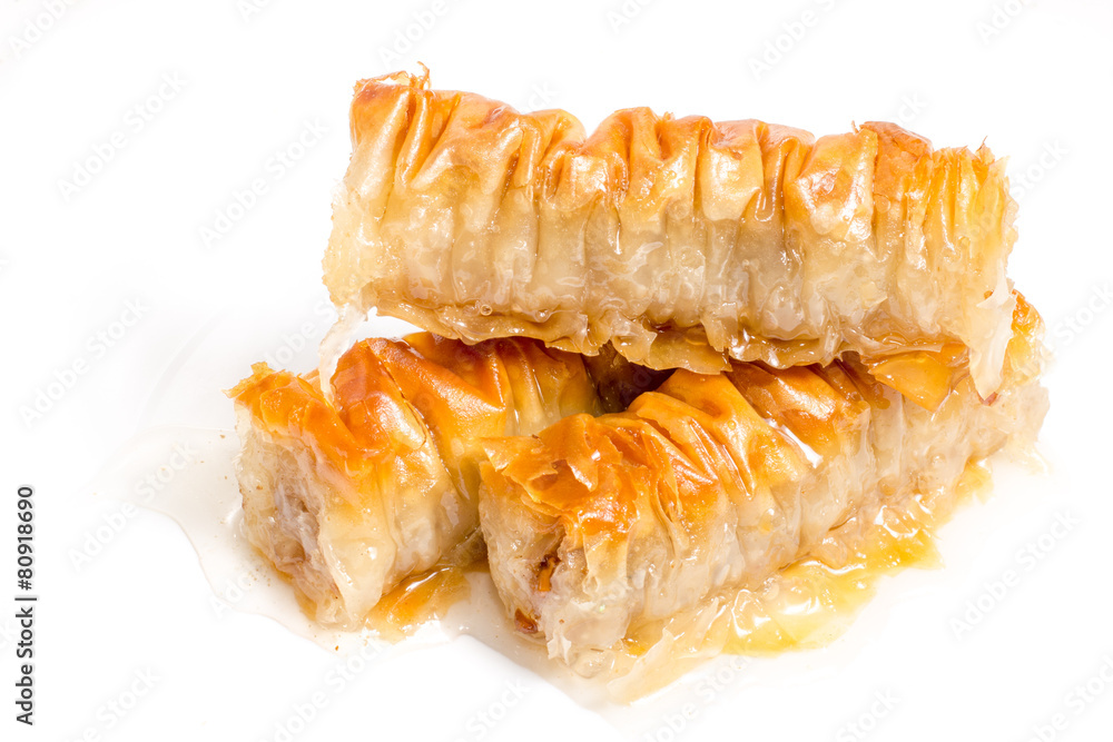 Baklava splashed with chocolate isolated on white background Baklava splashed with chocolate isolated on white background