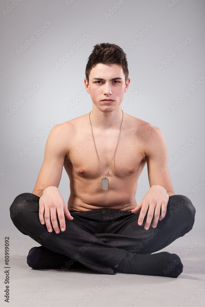 Fototapeta premium Healthy muscular young man on grey background