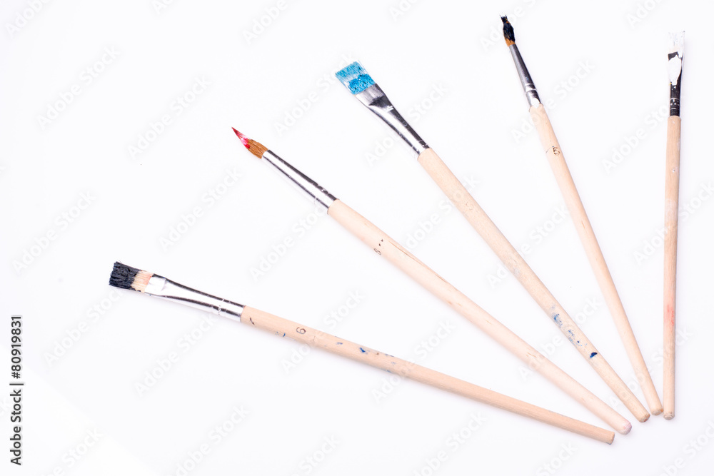 Five paintbrushes on a white background