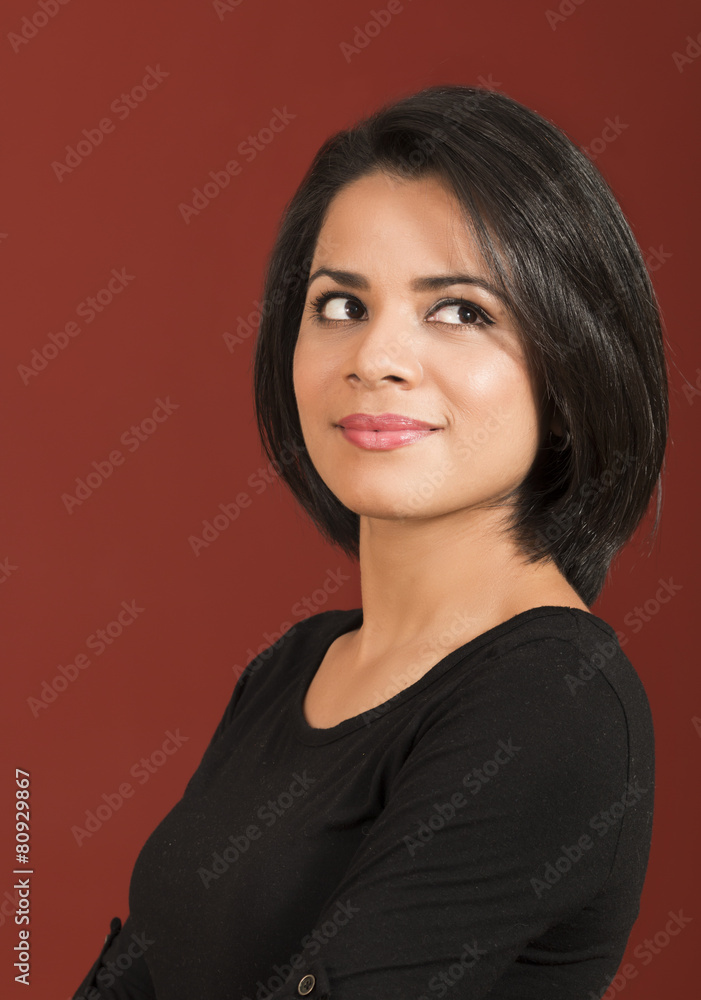 Obraz premium Beautiful thoughtful latin woman smiling