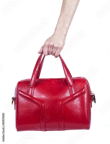 female hand holding a leather handbag