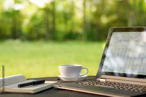 Laptop and coffee in outdoor office