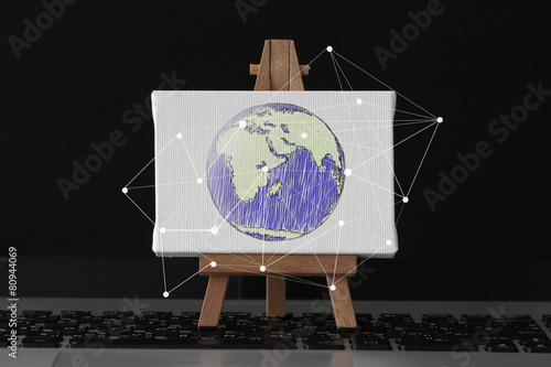 hand drawn globe with social network diagram on canvas and woode