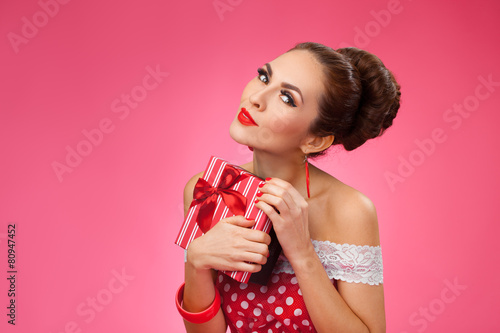 Excited Woman Holding Gift Box. Pin-up retro style.