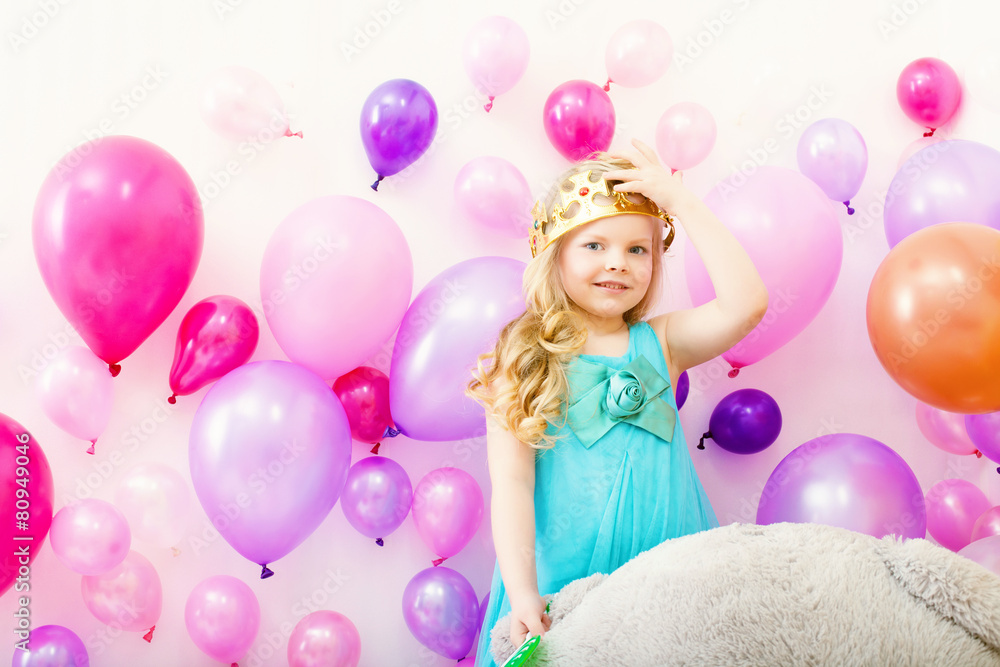 Obraz premium Image of comely little girl tries on toy crown