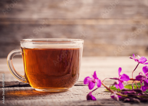 cup of tea with willow-herb on wooden background