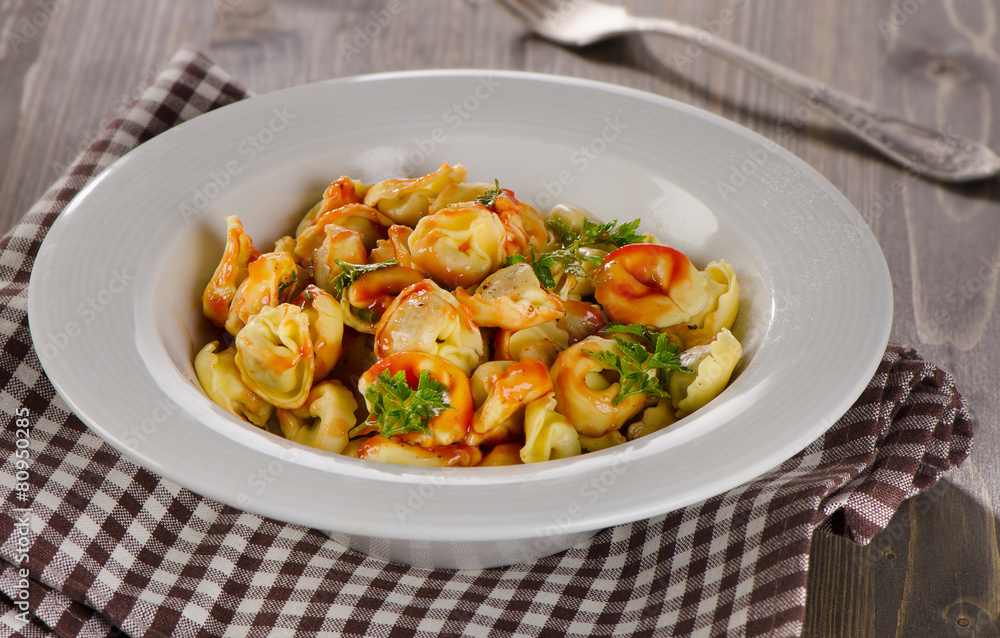 Ravioli pasta with tomato sauce and herbs. Ravioli pasta with tomato sauce and herbs.