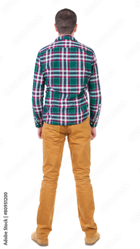 Fototapeta premium Back view of handsome man in checkered shirt looking up.