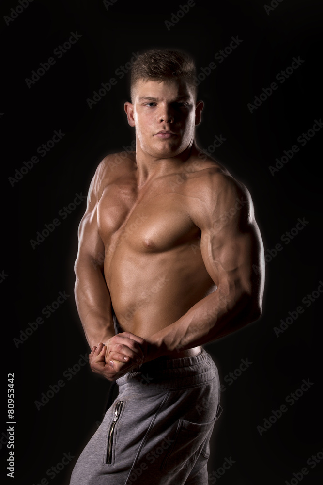 young muscular man on balck background