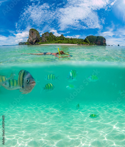 Fototapeta Naklejka Na Ścianę i Meble -  half above and underwater of a woman snorkeling in Thailand