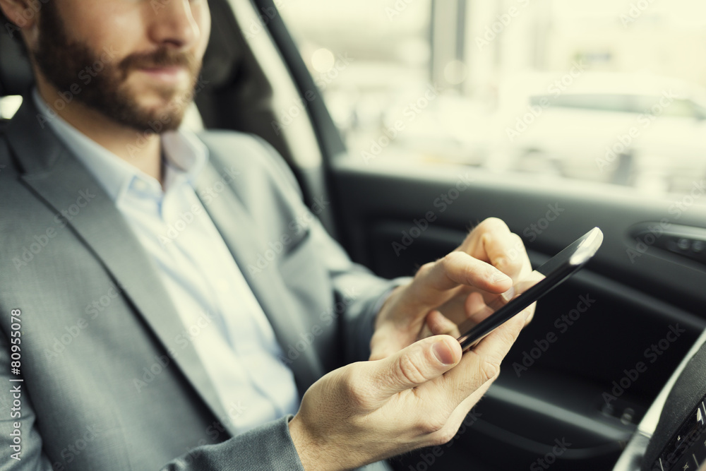 Man in car. Typing text message on mobile phone Man in car. Typing text message on mobile phone