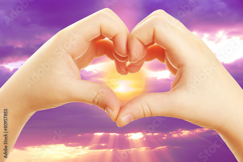 Heart shaped by hands on nature background