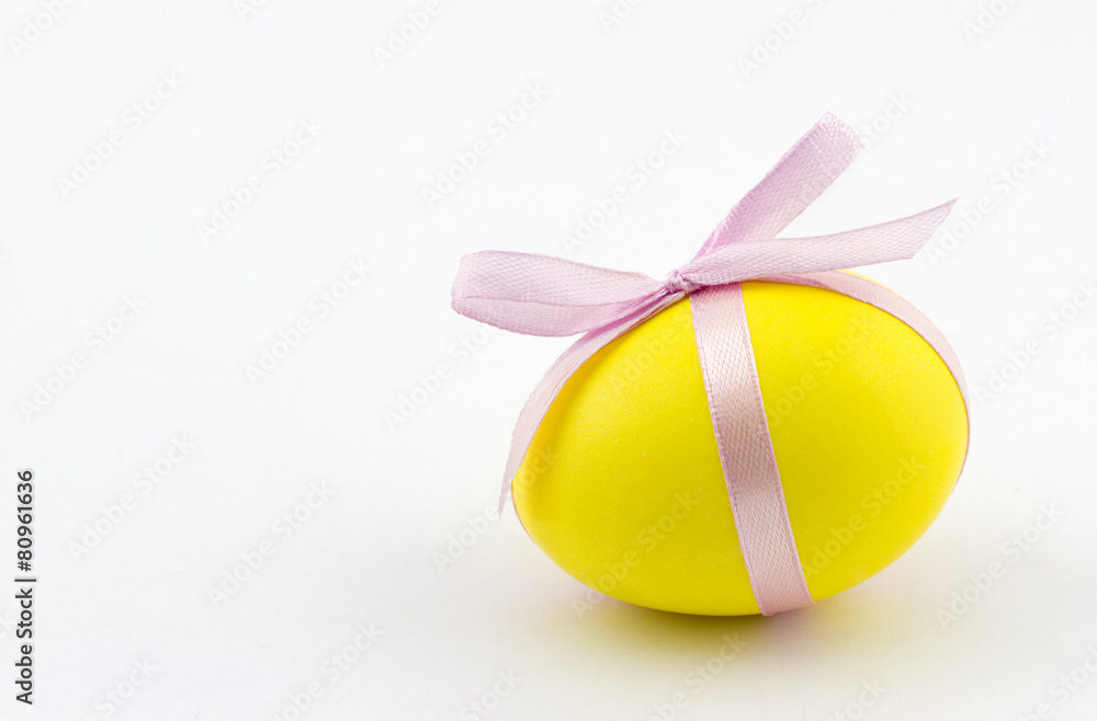 Happy Easter concept. Colorful painted Easter egg with pink bow