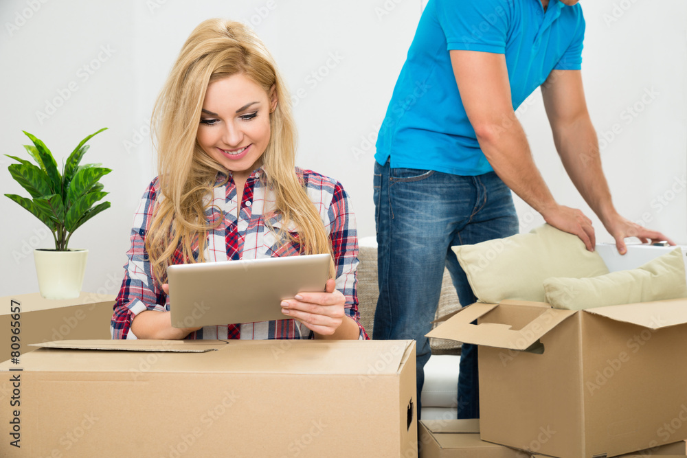 Woman Using Digital Tablet In New House
