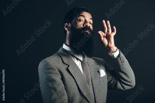 Man Holding his Mustache While Looking at Camera