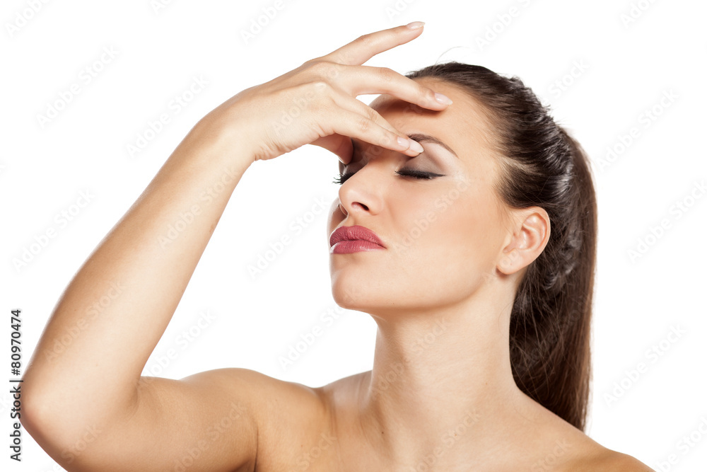 Tired beautiful woman has a headache and pain in the eyes Tired beautiful woman has a headache and pain in the eyes