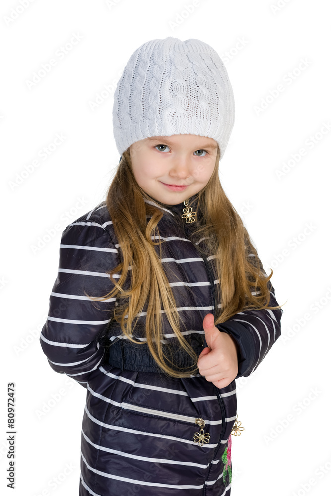 Little girl in a winter coat holds her thumb up Little girl in a winter coat holds her thumb up