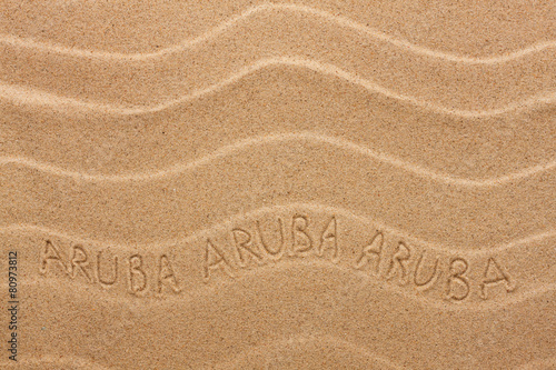 Aruba inscription on the wavy sand